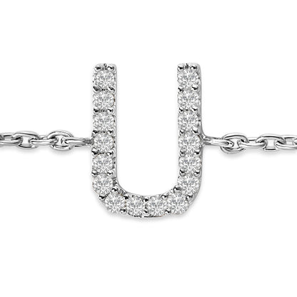 Close-up front view of a white metal bracelet with a U-shaped pendant set with round white gemstones in a micro-pave setting, shown on a white background.