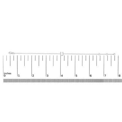 White bracelet with a central U-shaped charm set with white round gemstones in a micro-pave setting, shown on a ruler scale from a top-down angle.
