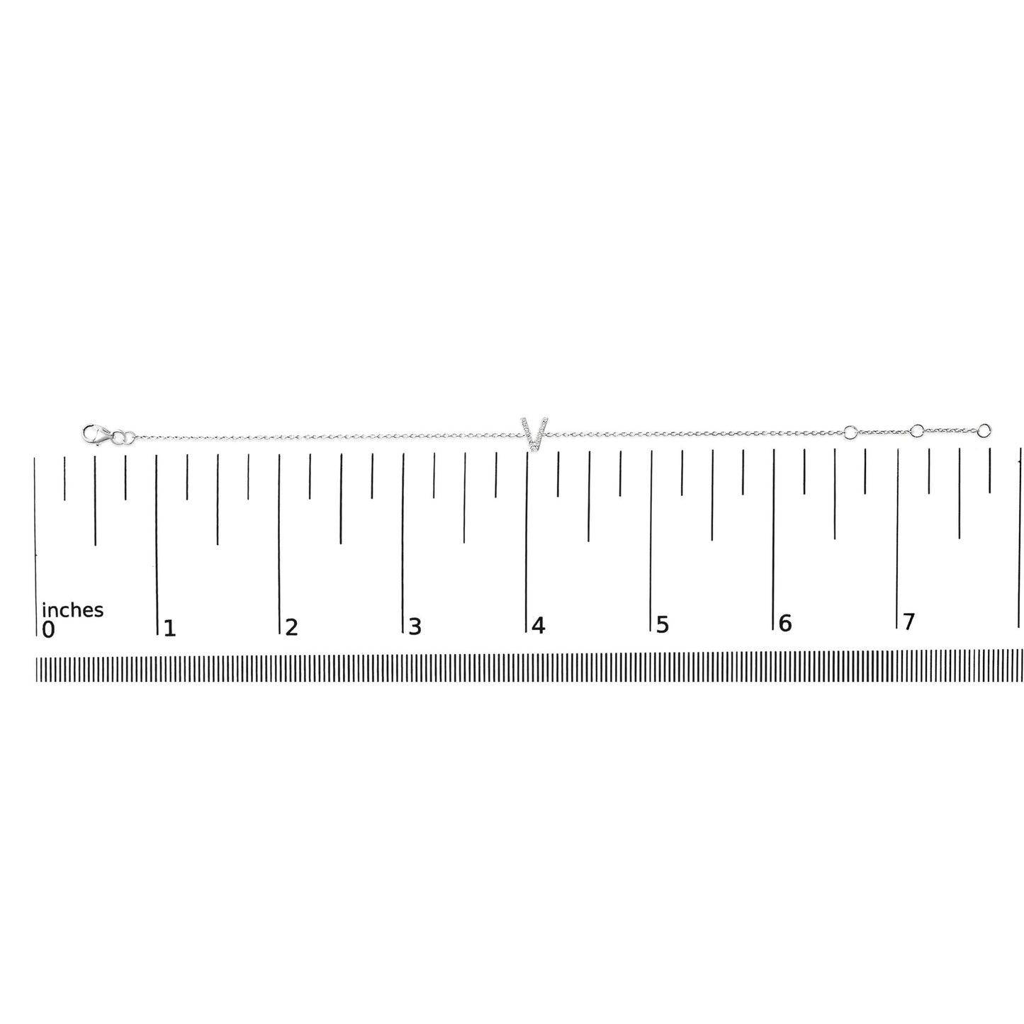 White metal bracelet with a central 'V' shape adorned with small white gemstones in a micro-pave setting, shown on a ruler scale from a top-down angle.