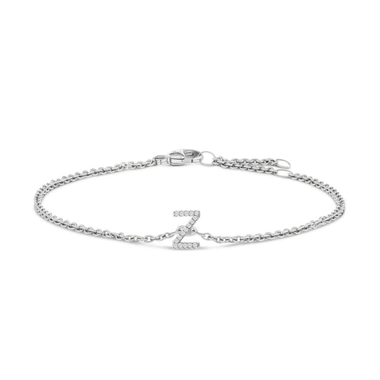 White metal bracelet with a round chain and a central letter 'Z' adorned with small white gemstones in a micro-pave setting, shown in a flat lay from a top angle.