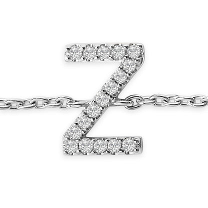 Close-up front view of a white metal bracelet featuring a 'Z' shaped charm adorned with round white gemstones in a micro-pave setting.