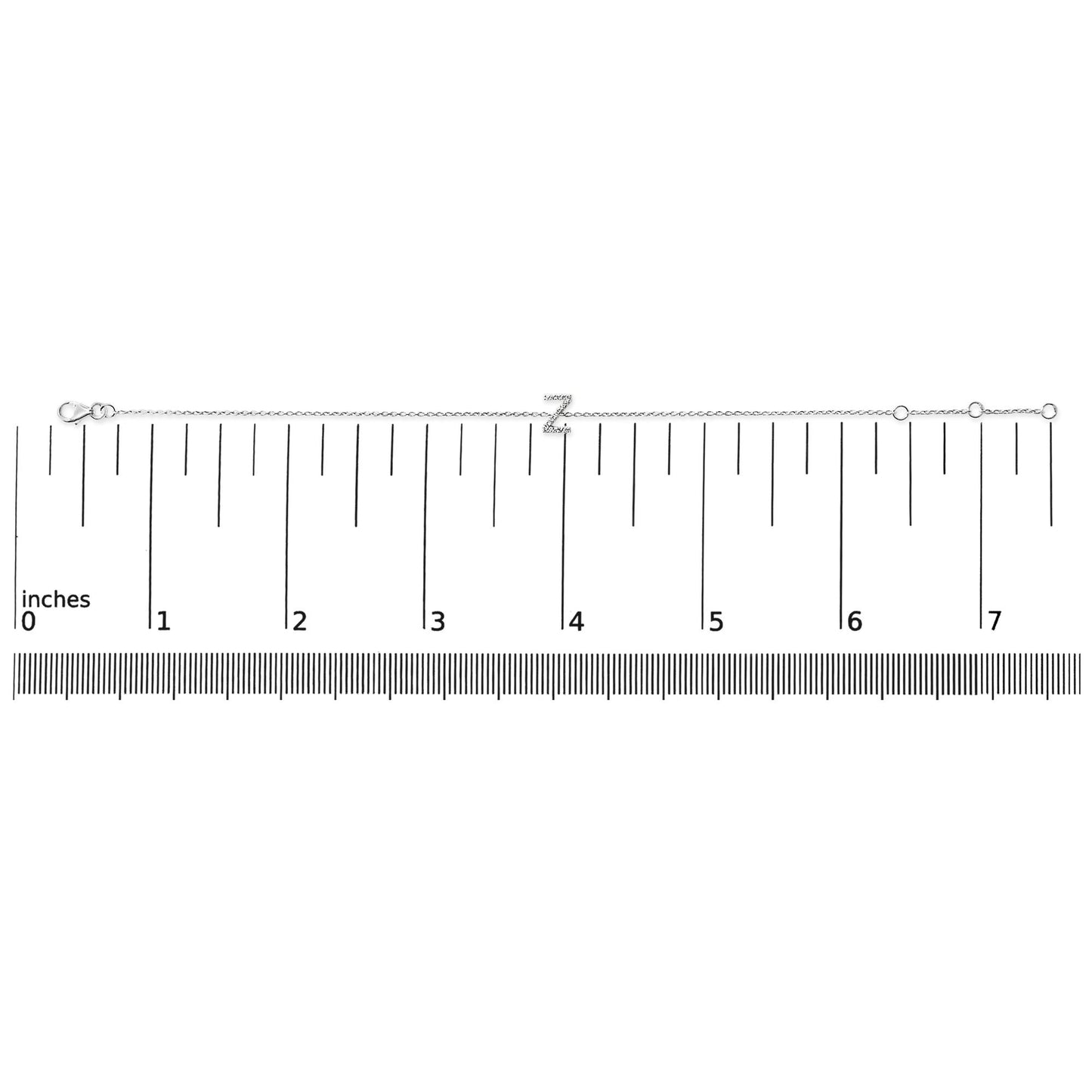 White metal bracelet with a 'Z' initial in micro-pave white gemstones, shown flat on a ruler for scale, top-down view.