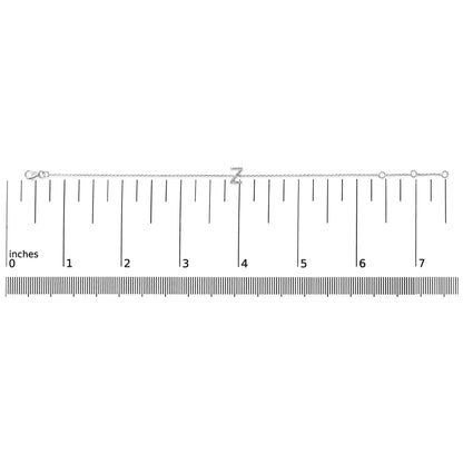 White metal bracelet with a 'Z' initial in micro-pave white gemstones, shown flat on a ruler for scale, top-down view.