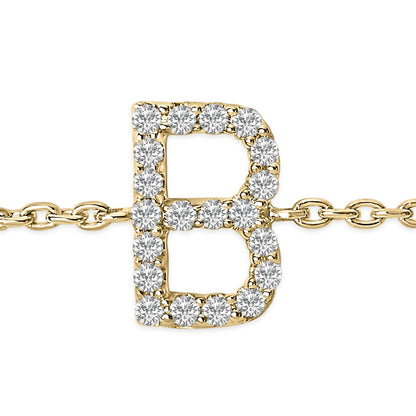 Close-up front view of a yellow metal bracelet featuring a letter 'B' charm adorned with round white gemstones in a micro-pave setting.