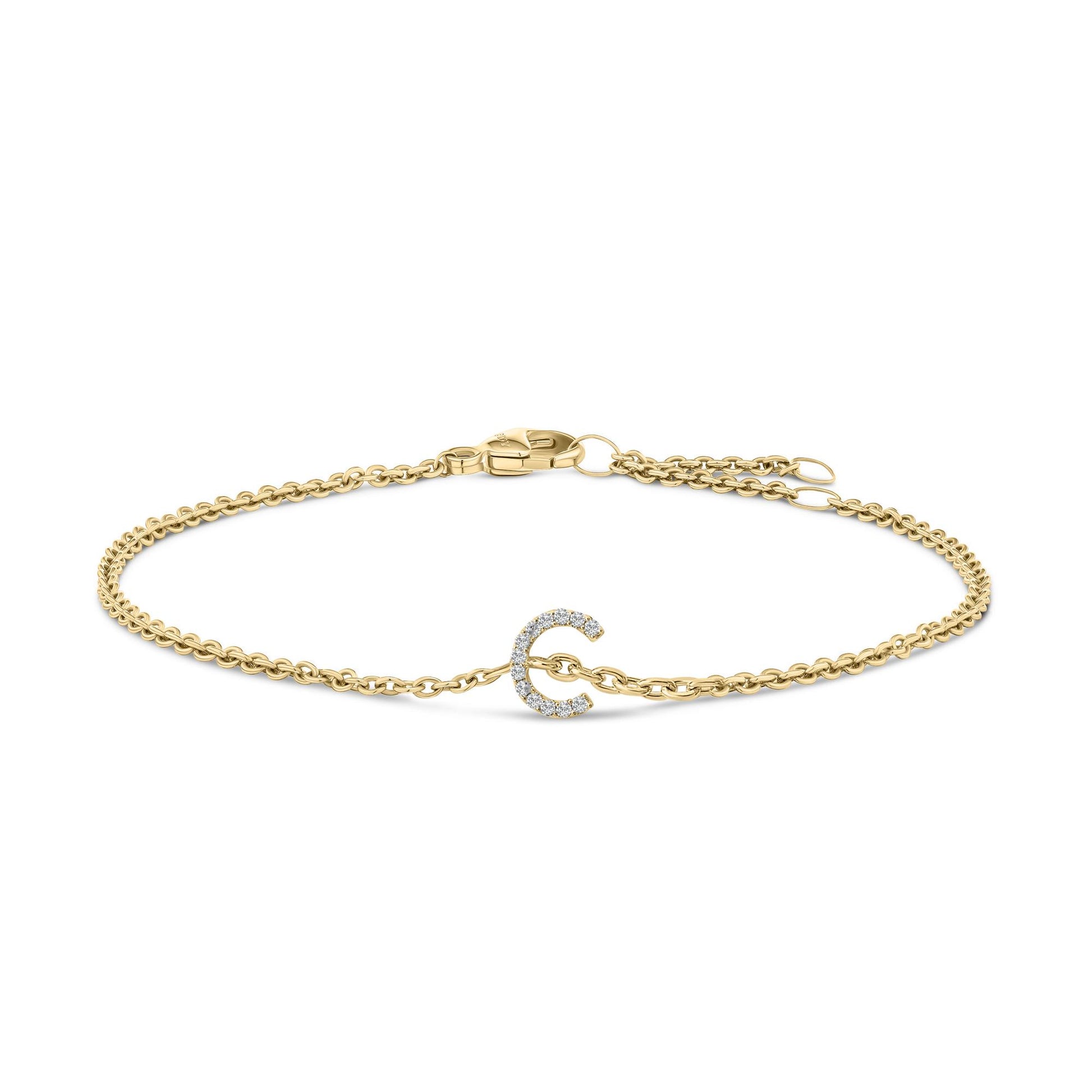 Yellow metal bracelet with a curved design element set with small white gemstones, displayed flat on a white background from a top front angle.