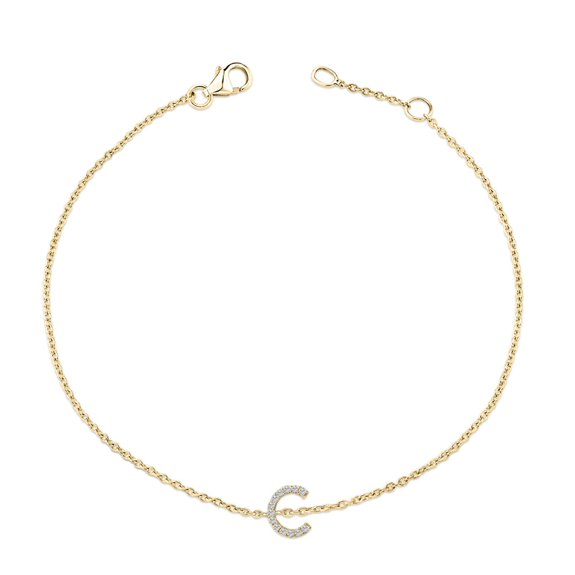 Yellow metal bracelet with a delicate chain and a curved charm set with small white gemstones, shown flat against a white background from a top-down angle.
