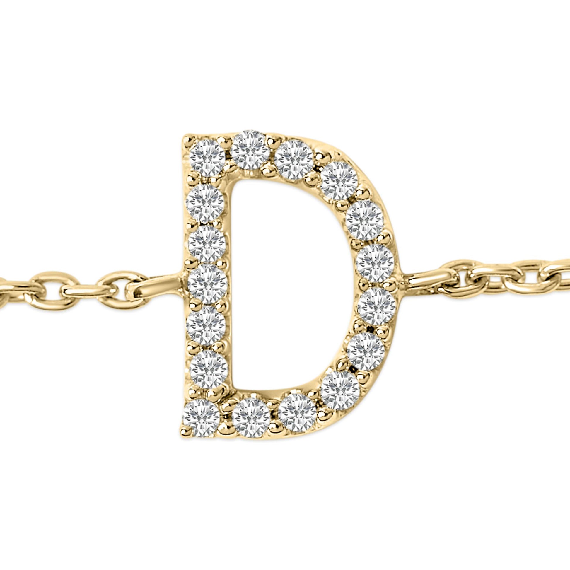 Close-up front angle of a yellow metal bracelet featuring a capital letter 'D' adorned with round white gemstones in a micro-pave setting.