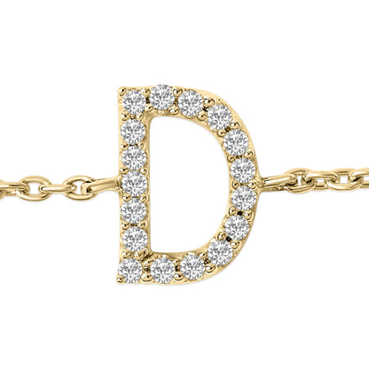Close-up front angle of a yellow metal bracelet featuring a capital letter 'D' adorned with round white gemstones in a micro-pave setting.