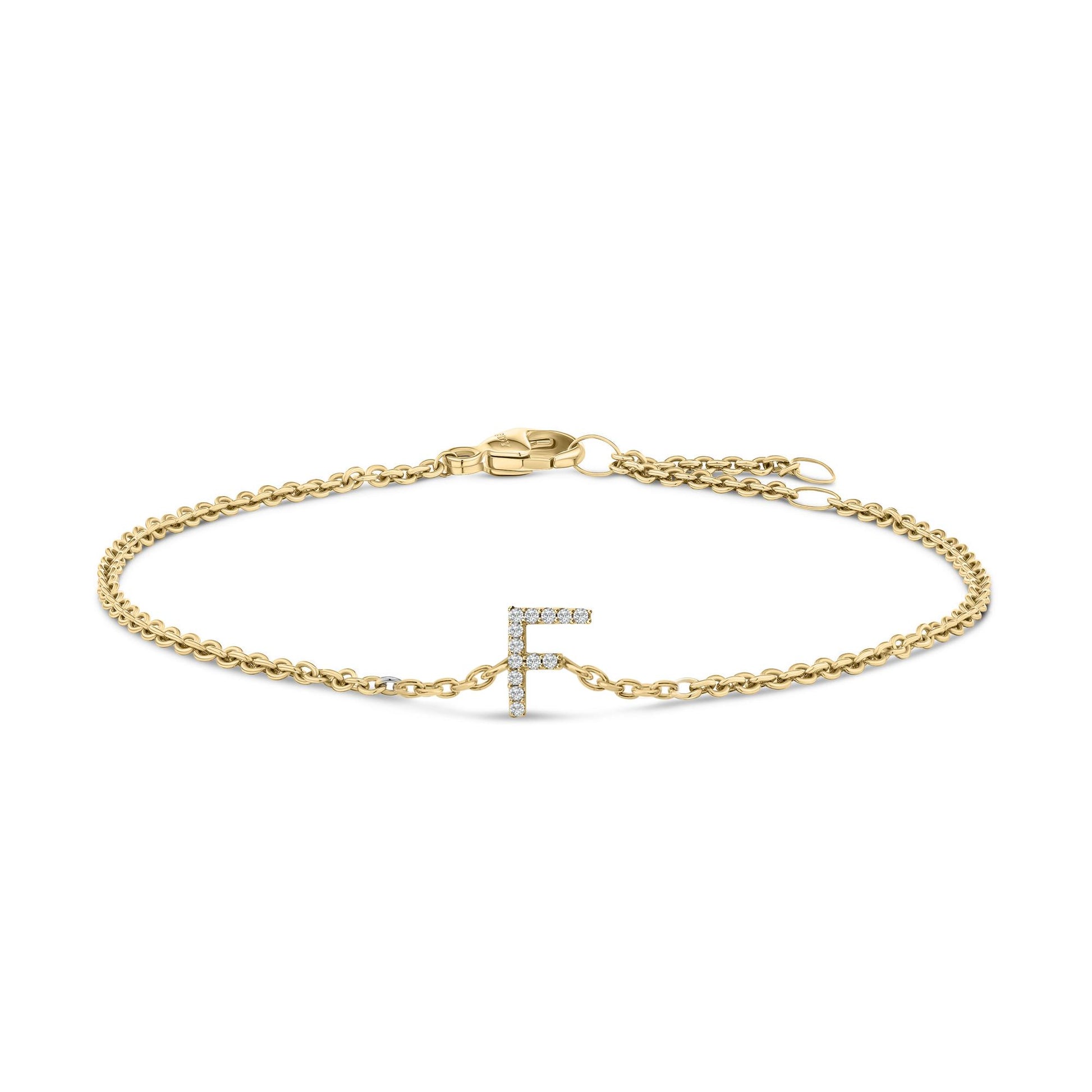 Front-facing shot of a yellow metal bracelet with a chain design and a micro-pave setting white gemstones forming the letter 'F' in the center, shown on a white background.