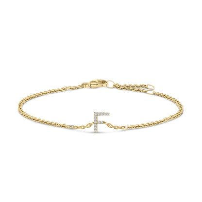 Front-facing shot of a yellow metal bracelet with a chain design and a micro-pave setting white gemstones forming the letter 'F' in the center, shown on a white background.
