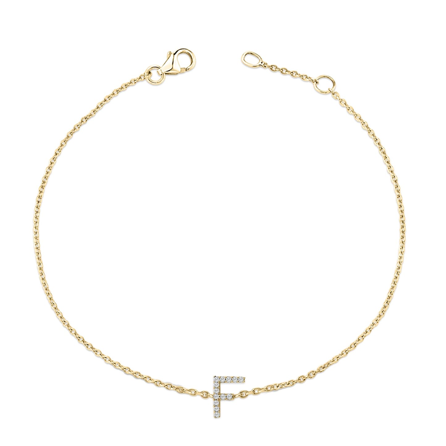 Top-down view of a delicate yellow bracelet with a chain and a letter 'F' charm encrusted with small white gemstones in a micro-pave setting.
