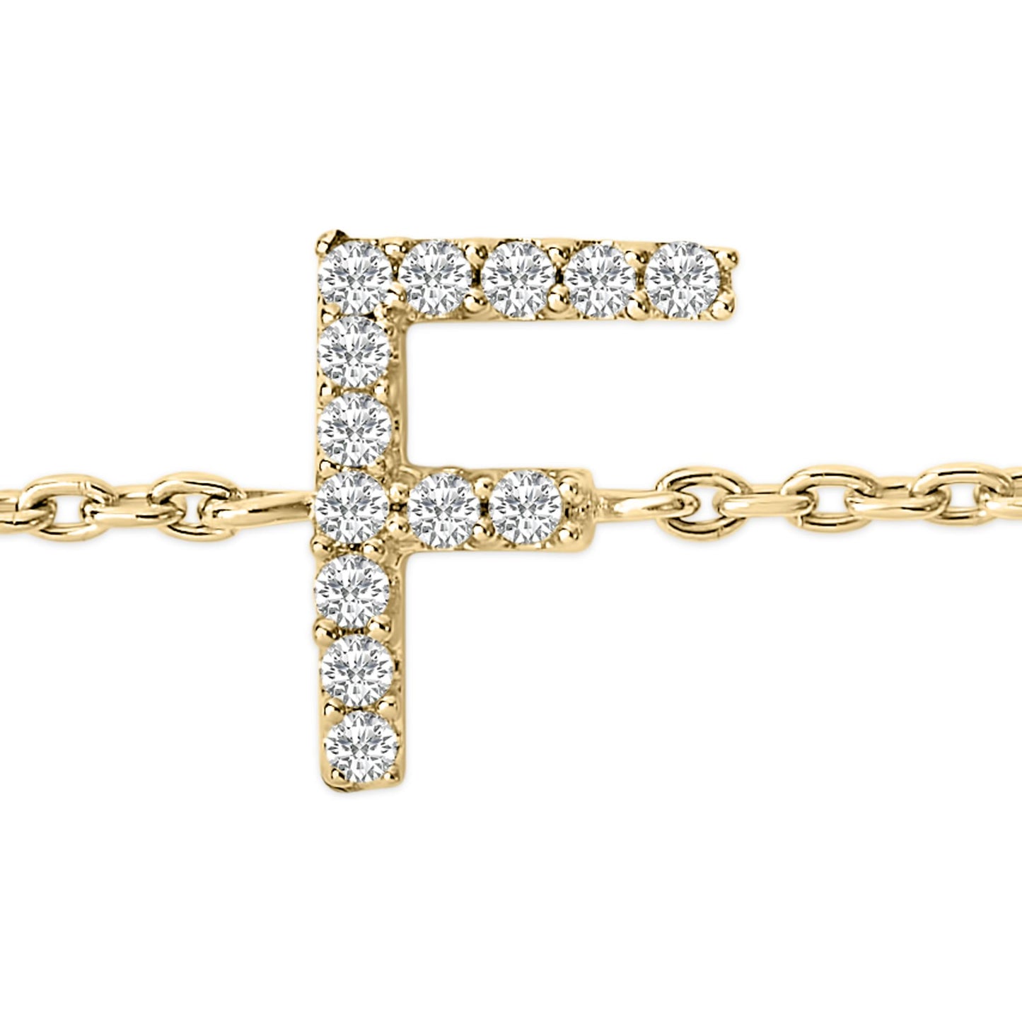 Close-up front angle of a yellow metal bracelet featuring an 'F' shaped charm adorned with round white gemstones in a micro-pave setting, shown on a white background.