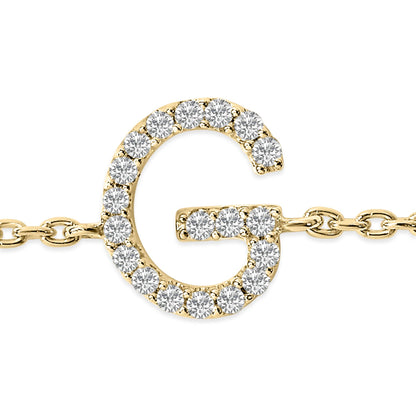 Close-up shot of a yellow metal bracelet featuring a letter G pendant adorned with white round gemstones in a micro-pave setting, shown from the front.