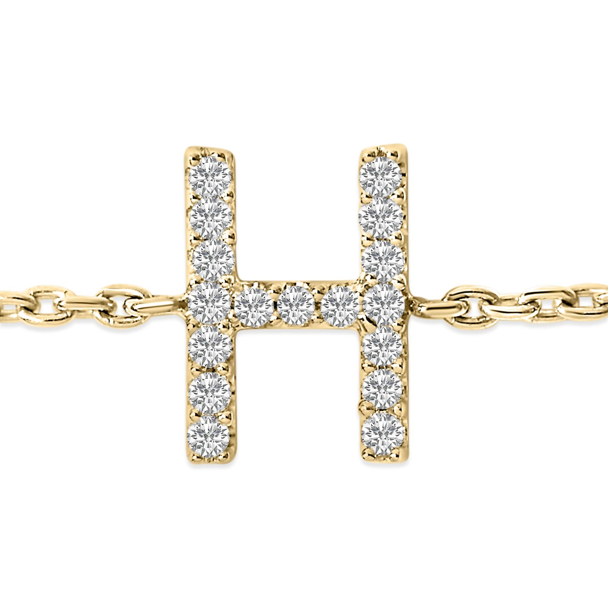Close-up front view of a yellow metal bracelet with a horizontal and vertical bar design forming an 'H' shape, encrusted with small white round gemstones in a micro-pave setting.