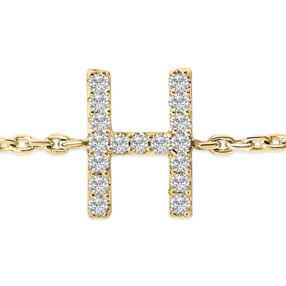 Close-up front view of a yellow metal bracelet with a horizontal and vertical bar design forming an 'H' shape, encrusted with small white round gemstones in a micro-pave setting.