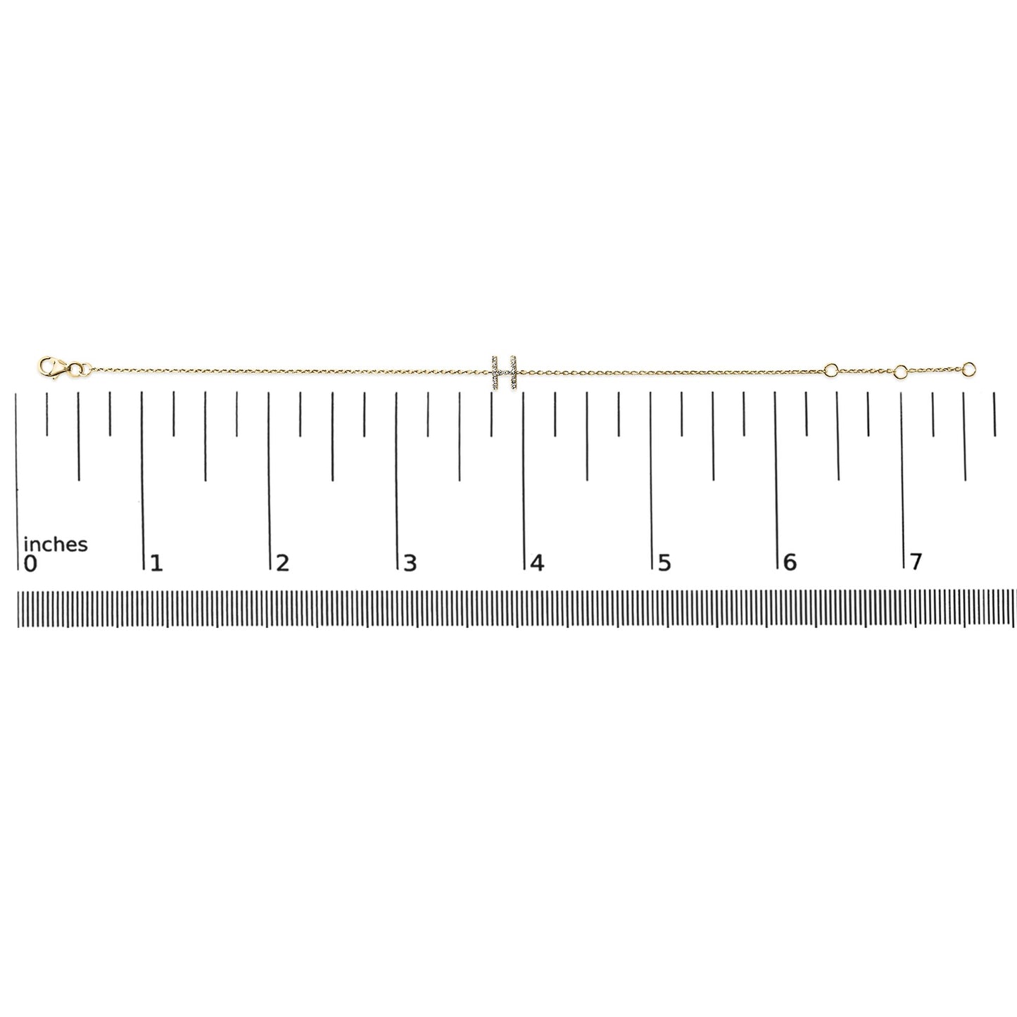 Yellow metal bracelet with a double bar centerpiece featuring small white gemstones in a micro-pave setting, shown on a scale from a top view.