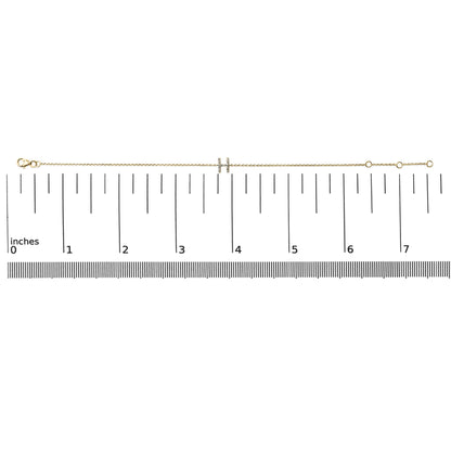 Yellow metal bracelet with a double bar centerpiece featuring small white gemstones in a micro-pave setting, shown on a scale from a top view.