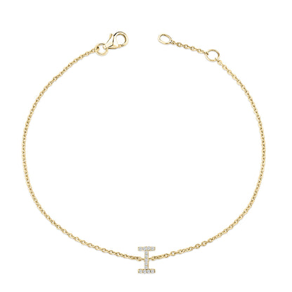 Yellow bracelet with a small horizontal bar charm set with white gemstones in a micro-pave setting, shown flat from a top-down angle.