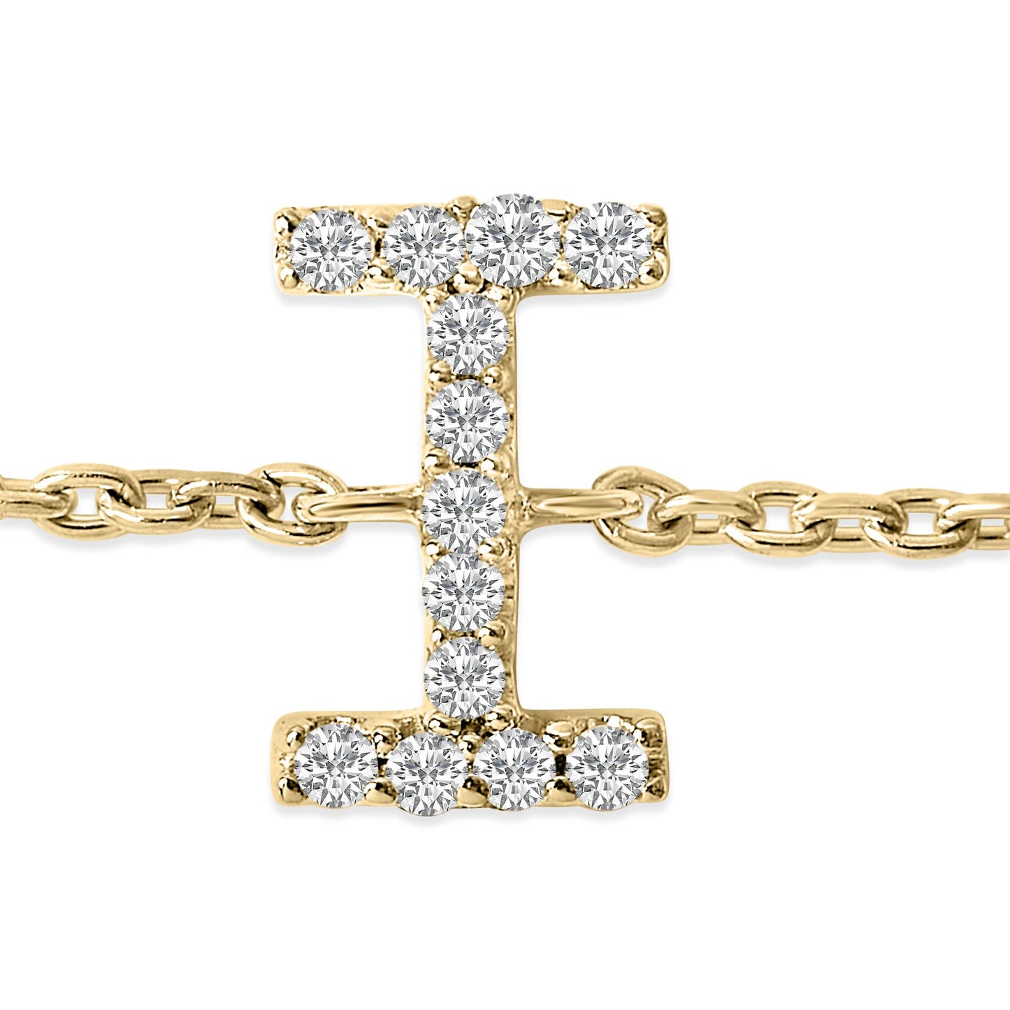 Close-up front view of a yellow metal bracelet featuring a capital letter 'I' charm adorned with multiple round white gemstones in a micro-pave setting. The bracelet chain is visible extending from both sides of the charm.