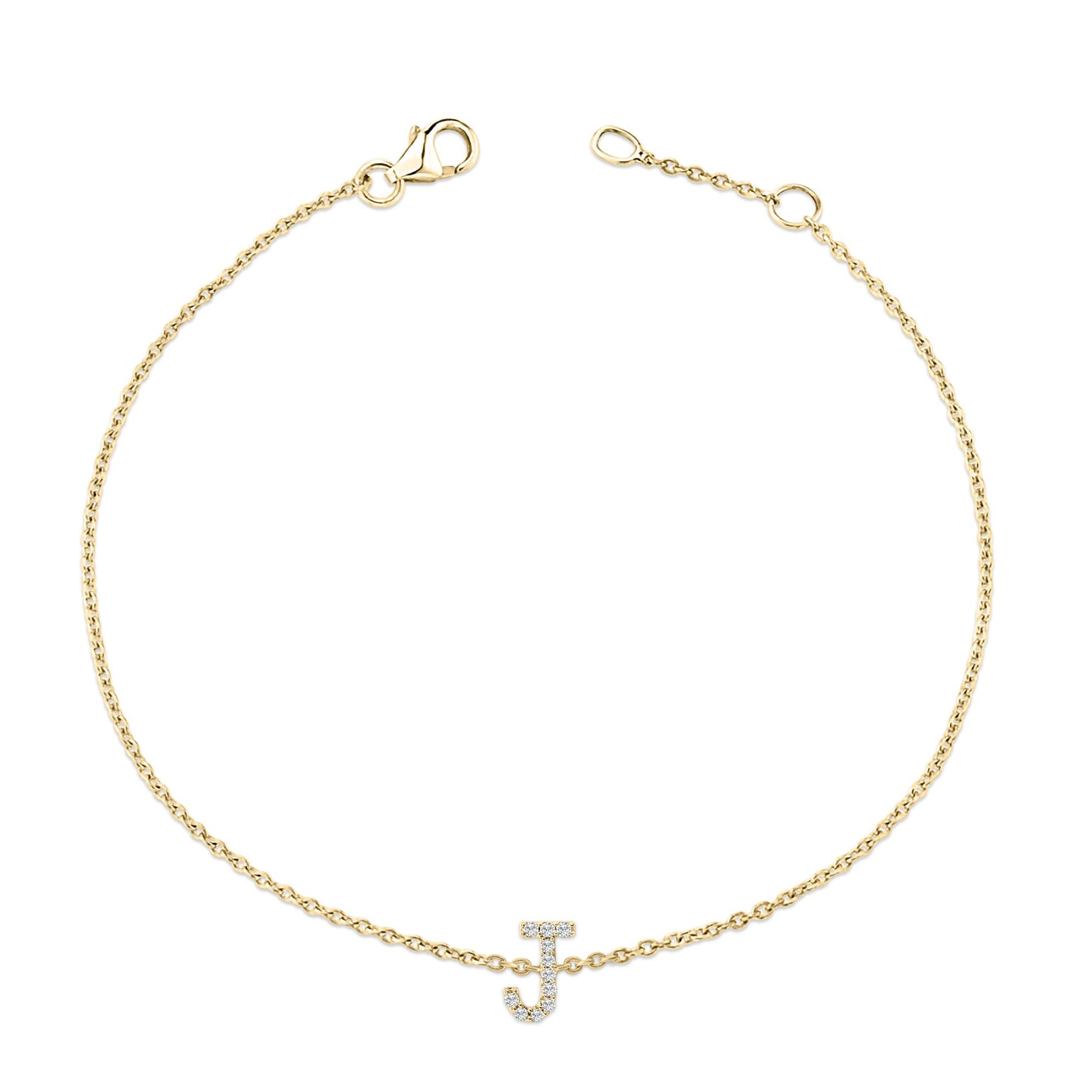 Top-down view of a yellow metal bracelet with a chain design and an initial letter charm adorned with white round gemstones in a micro-pave setting.