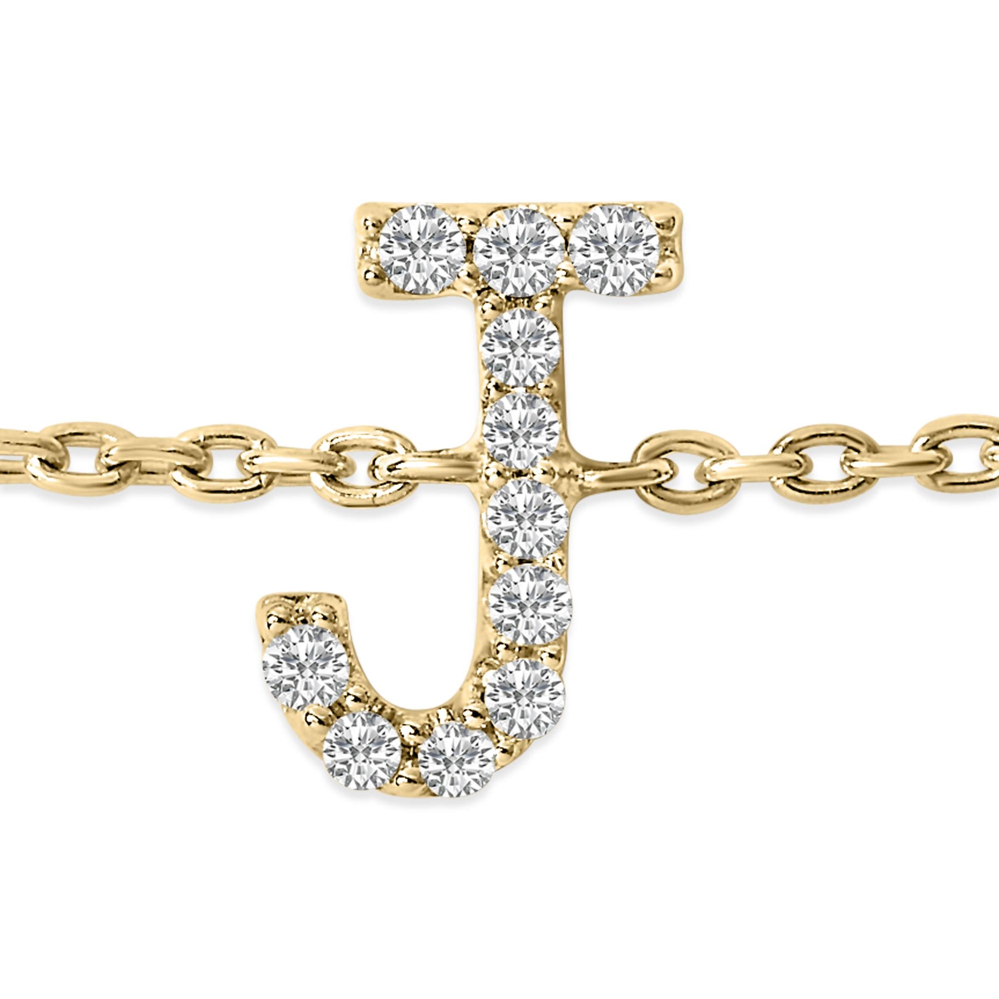 Close-up front view of a yellow bracelet chain featuring a letter J shaped charm adorned with round white gemstones in a micro-pave setting.