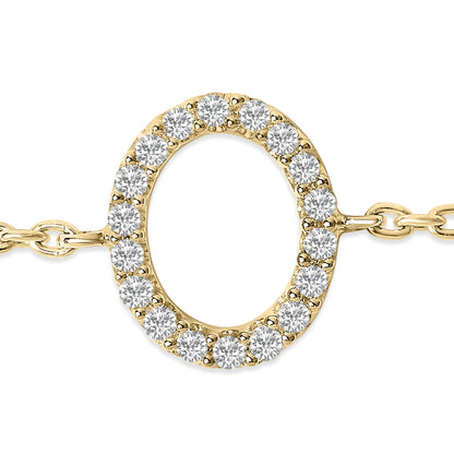 Close-up front angle of a yellow metal bracelet featuring a circular centerpiece set with small round white gemstones in a micro-pave setting, shown on a white background.