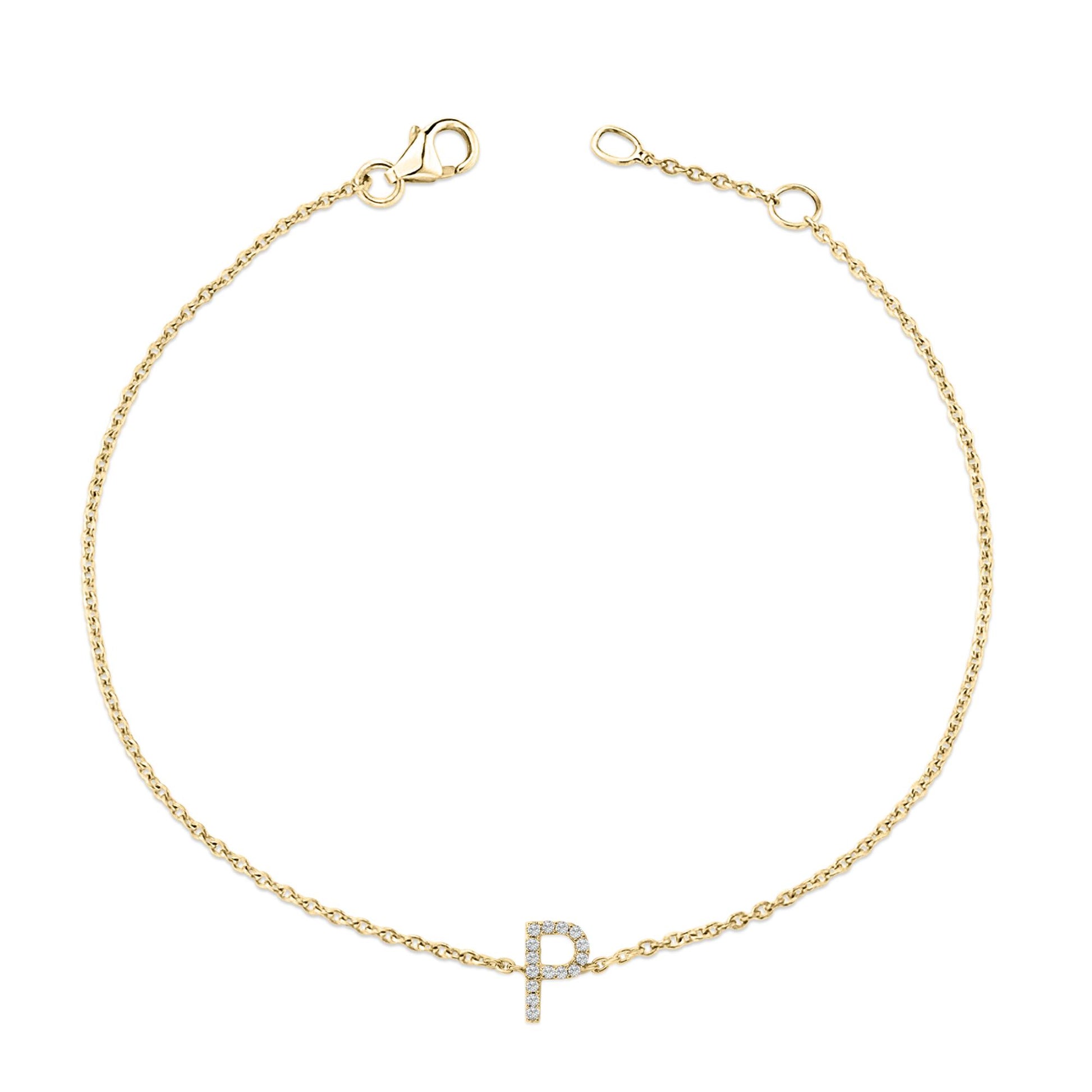 Bracelet with a delicate yellow chain and a centered letter 'P' charm adorned with small white gemstones, shown from above on a white background.