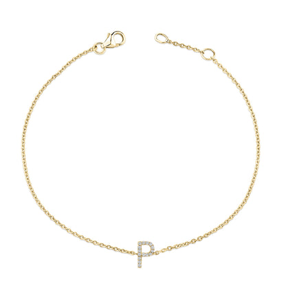 Bracelet with a delicate yellow chain and a centered letter 'P' charm adorned with small white gemstones, shown from above on a white background.