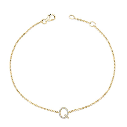 Yellow metal bracelet shown from above with a chain and a circular pendant featuring white gemstones in a micro-pave setting.