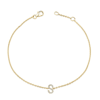 Yellow metal bracelet with a chain and a letter 'S' charm adorned with small white gemstones in a micro-pave setting, shown from a top-down angle.