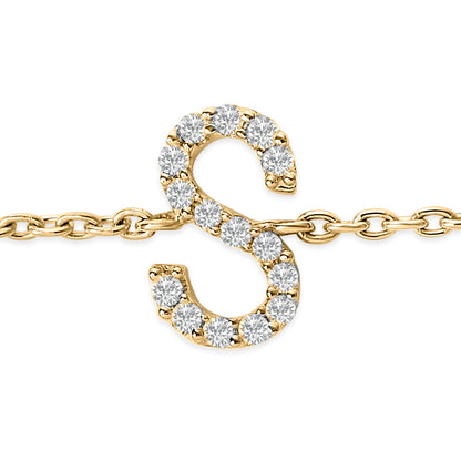 Close-up front view of a yellow metal bracelet featuring an 'S' shaped charm adorned with round white gemstones in a micro-pave setting.
