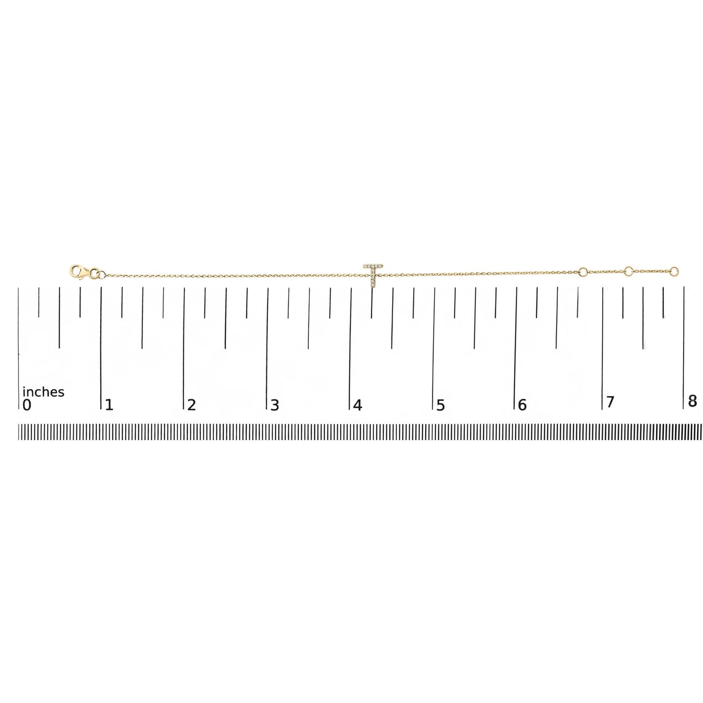 Yellow bracelet with a 'T' shaped centerpiece adorned with white round gemstones in micro-pave setting, shown lying flat on a ruler for scale, top-down view.