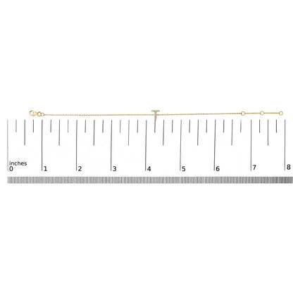 Yellow bracelet with a 'T' shaped centerpiece adorned with white round gemstones in micro-pave setting, shown lying flat on a ruler for scale, top-down view.