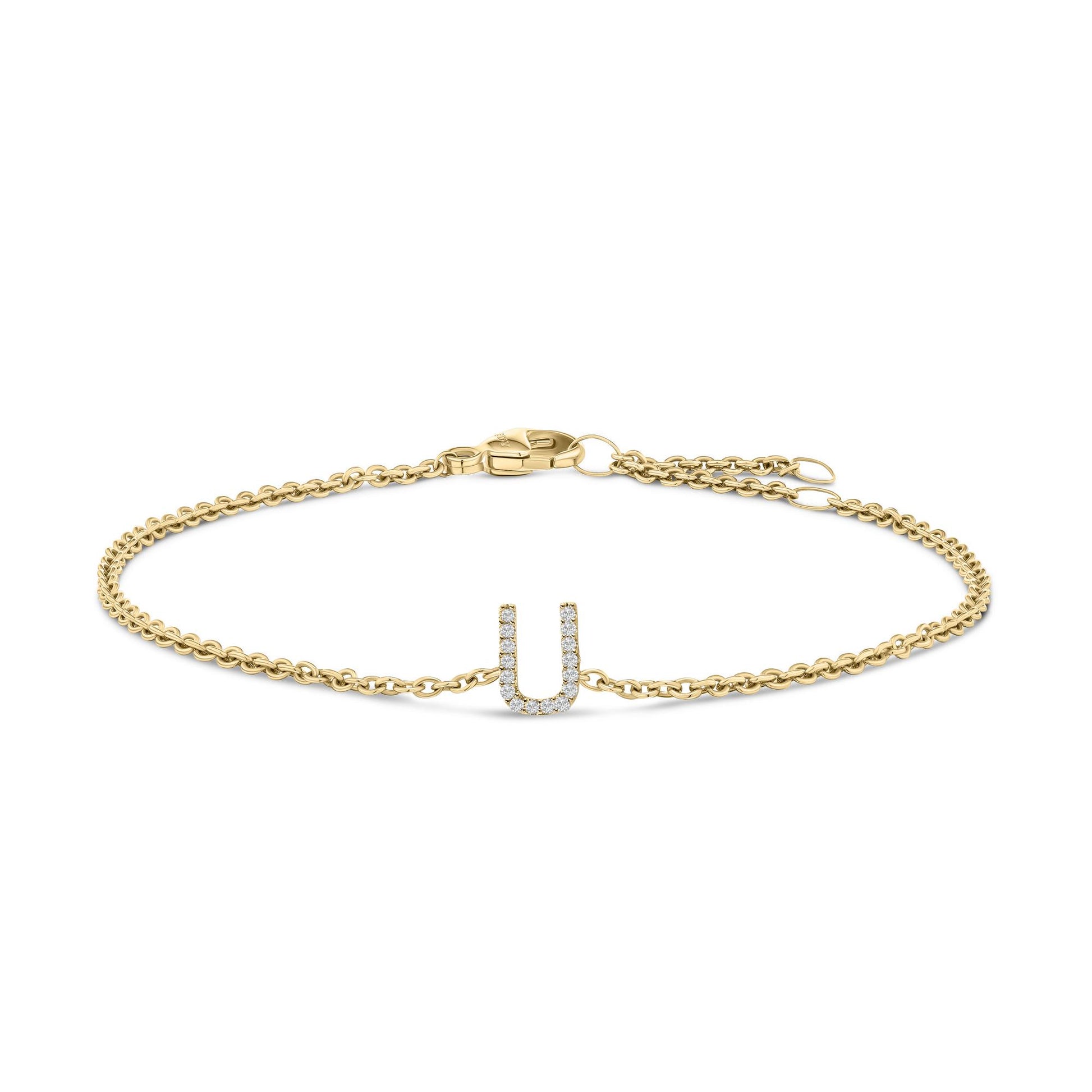 Yellow metal bracelet with a U-shaped charm set with white round gemstones in a micro-pave setting, shown flat from a top angle.