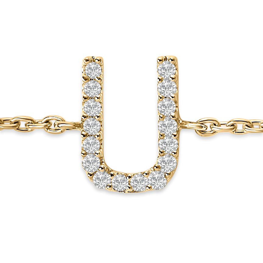 Close-up front view of a yellow bracelet featuring a U-shaped pendant adorned with round white gemstones in a micro-pave setting, connected to a chain on both sides.