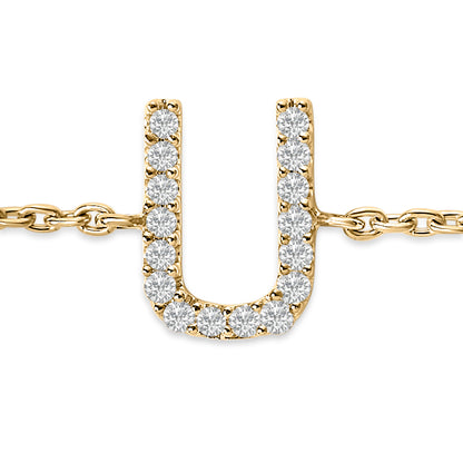 Close-up front view of a yellow bracelet featuring a U-shaped pendant adorned with round white gemstones in a micro-pave setting, connected to a chain on both sides.