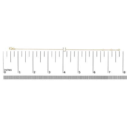 Yellow bracelet with chain and U-shaped centerpiece featuring white gemstones in a micro-pave setting, shown flat on a scale from above.