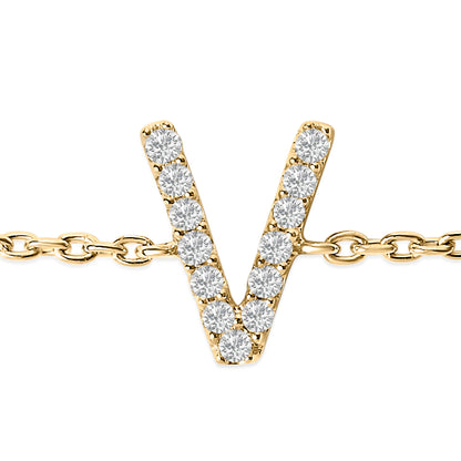 Close-up front view of a yellow metal bracelet with a V-shaped charm set with white round gemstones in a micro-pave setting, shown on a white background.