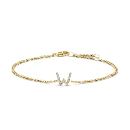 Yellow bracelet with a chain link band and a letter W centerpiece paved with small white gemstones, shown flat against a white background from a top down angle.