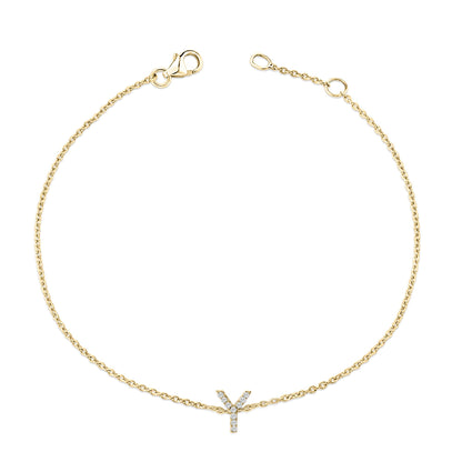 Yellow metal bracelet with a delicate chain and a central letter Y pendant set with small white gemstones, shown flat from a top-down angle.
