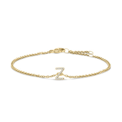 Yellow metal bracelet with a central 'Z' letter charm adorned with white gemstones in a micro-pave setting, shown from a front angle on a white background.