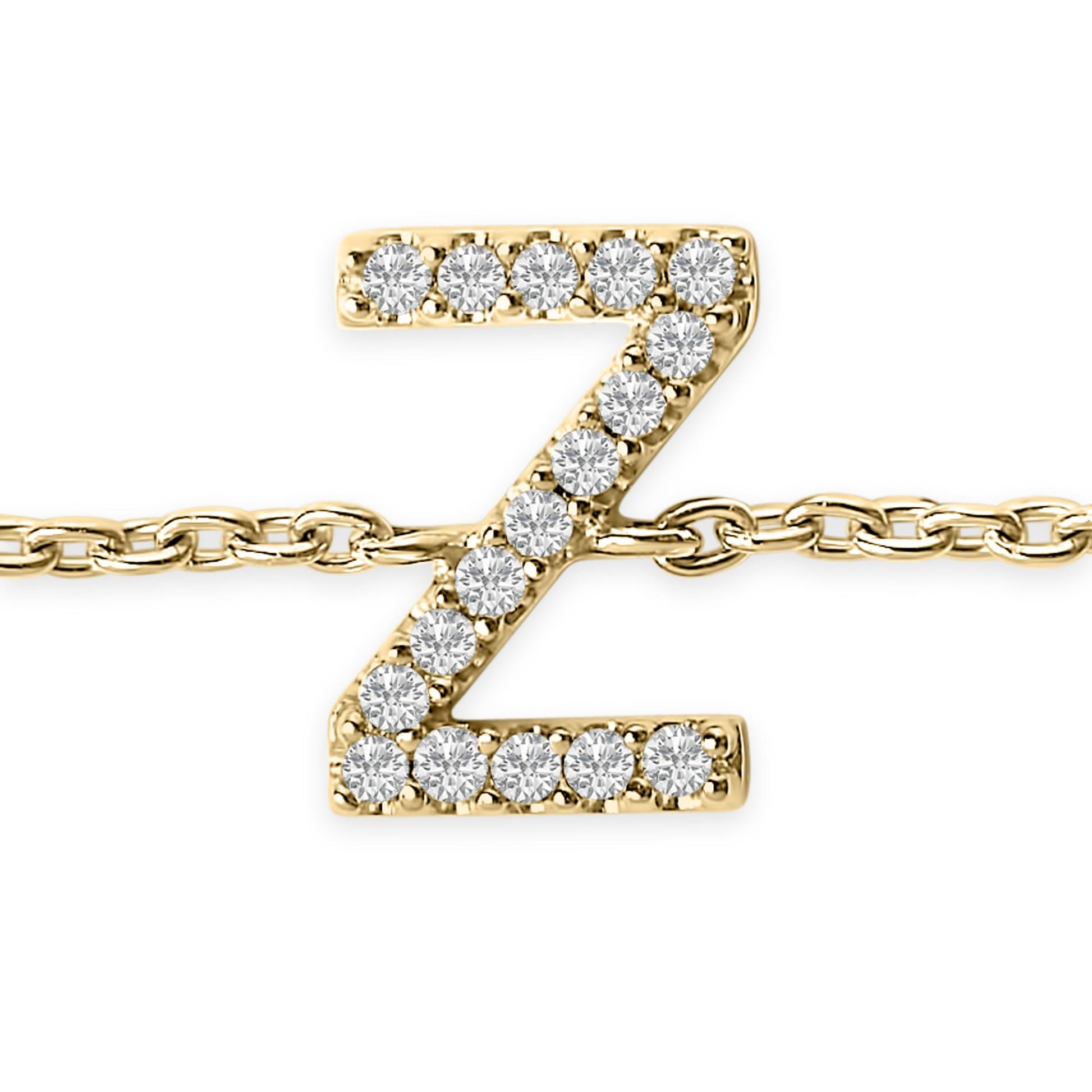 Close-up front view of a yellow metal bracelet featuring a pendant in the shape of the letter Z adorned with white round gemstones in a micro-pave setting, shown against a white background.