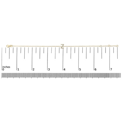 Yellow metal bracelet with a letter 'Z' charm set with white round gemstones in micro-pave setting, displayed flat on a scale, top-down view.