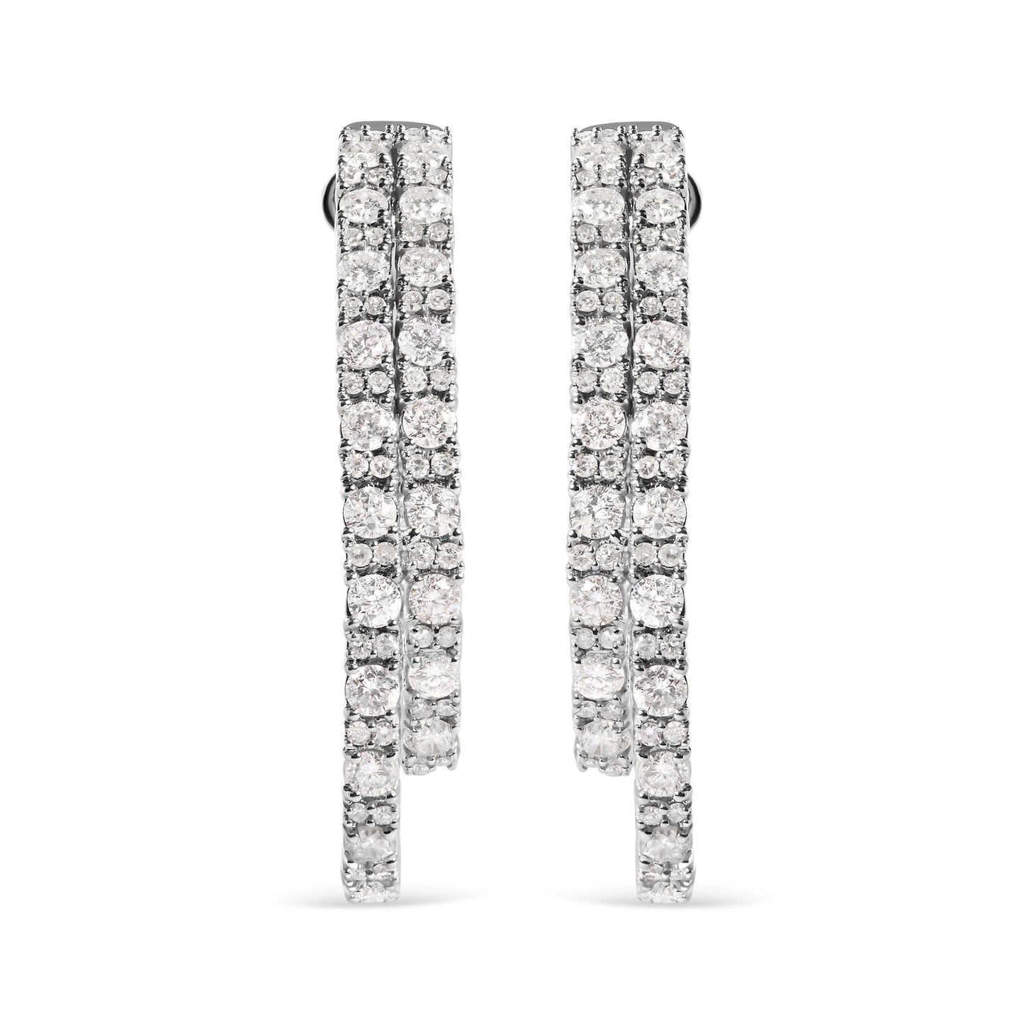 Front-facing view of a pair of white metal hoop earrings encrusted with multiple rows of round white gemstones in a prong setting.