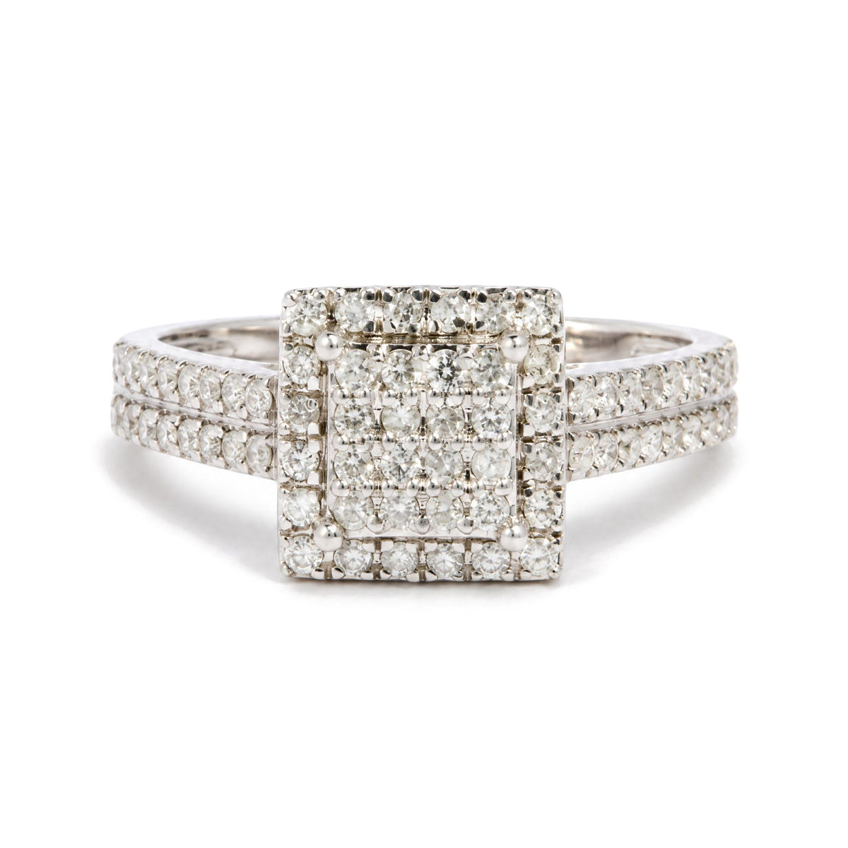 Close-up front view of a white metal ring featuring a square cluster of round white gemstones in prong settings, with rows of similar gemstones detailing the band.