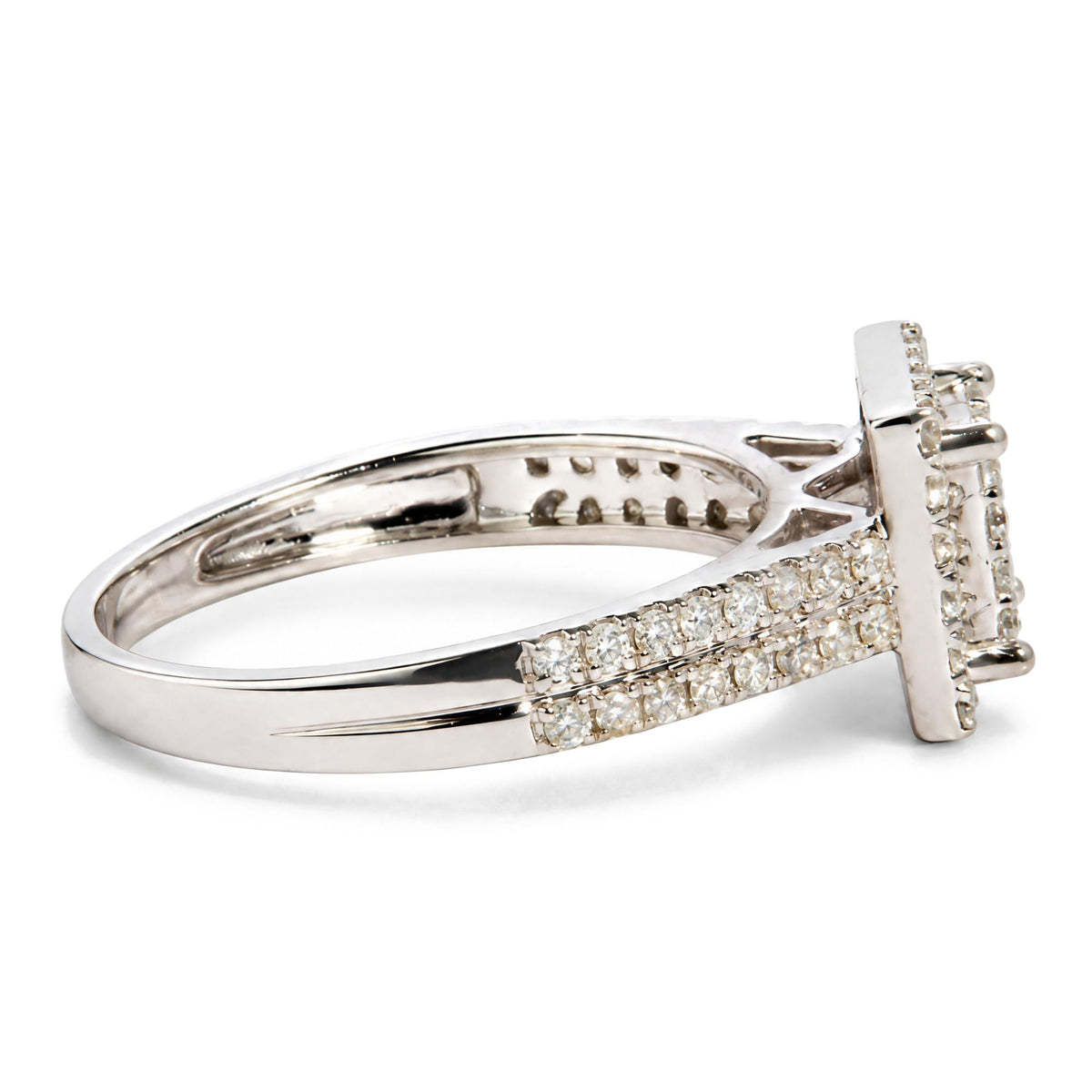 Close-up side view of a white metal ring with a split shank design, featuring multiple rows of round white gemstones in prong settings.