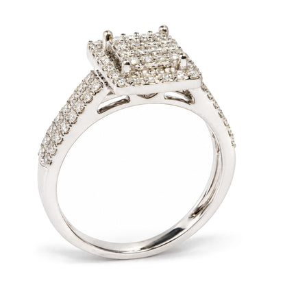 Close-up side angle of a white metal ring featuring a square cluster of prong-set round white gemstones, with two rows of additional round white gemstones along the band.