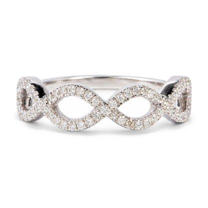 Close-up front angle of a white metal ring with two interlocking oval shapes, each paved with round white gemstones in prong settings.
