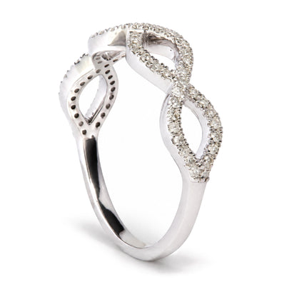 Close-up angled view of a white metal ring featuring an intertwined loop design set with multiple round white gemstones in prong settings.