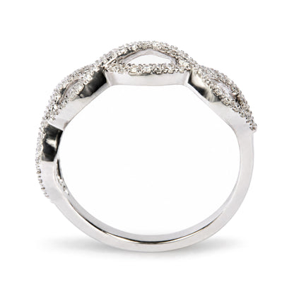 Close-up front angle of a white metal ring with round white gemstones in prong settings along the top edge.